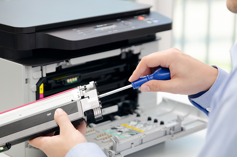 IT technical courier repairing a printer